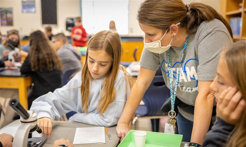 Students use microscopes in science class